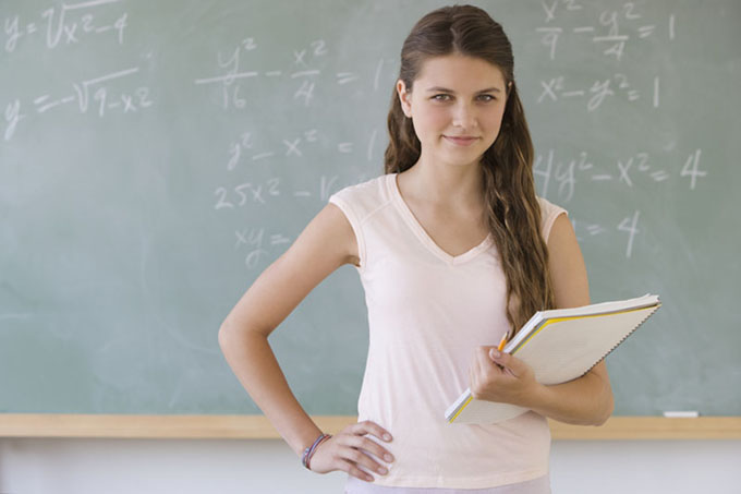 Girl standing in front of blackboard